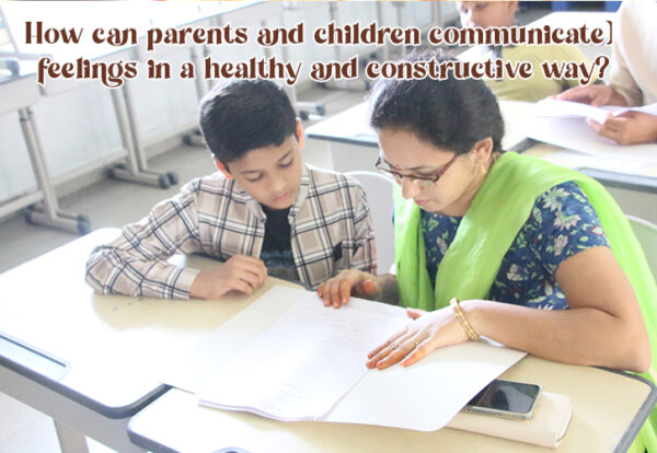 A teacher and a child looking at a piece of paper, communicating with each other