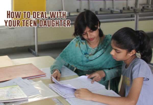 A mother helping her teen daughter in her studies