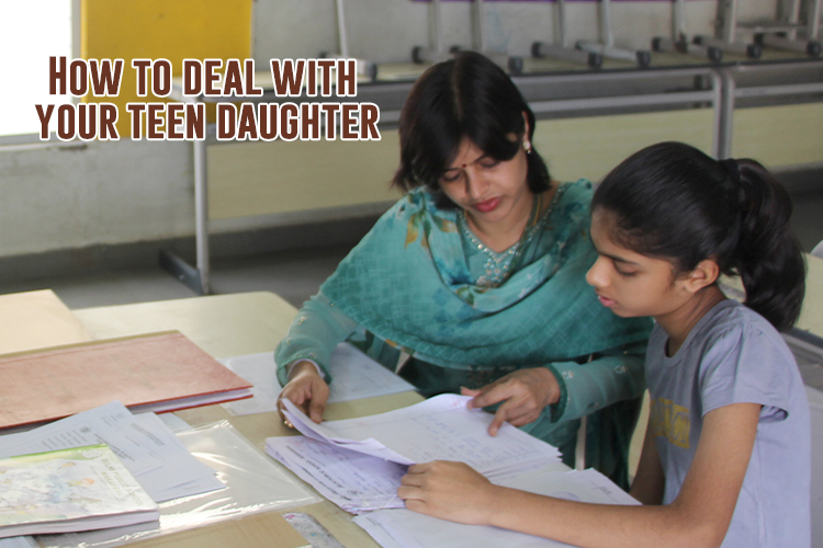 A mother helping her teen daughter in her studies