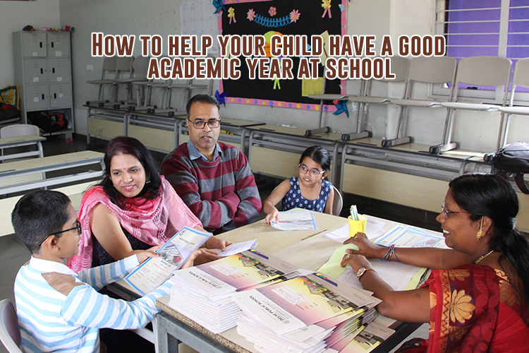 A group of DPS parents engaged in academic discussion while seated at a table.