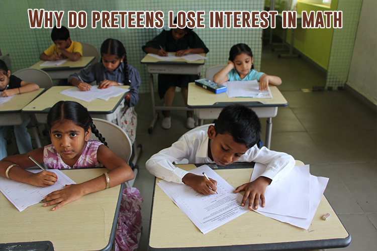 A group of children sitting at desks in a classroom doing math questions