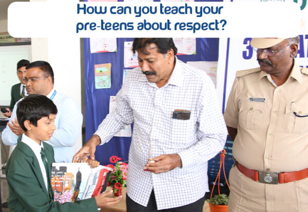 A pre-teen standing beside a man and police man who is teaching him about respect for others