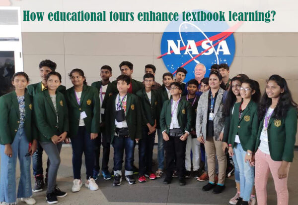 A group of students in green blazers poses at NASA, highlighting the benefits of educational tours.