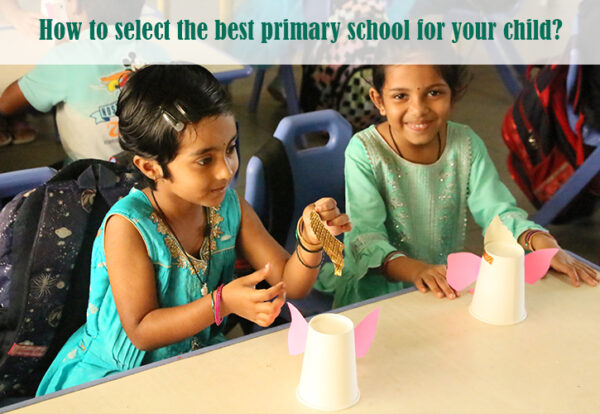 Two children engaged in a classroom activity in the best primary school for kids.