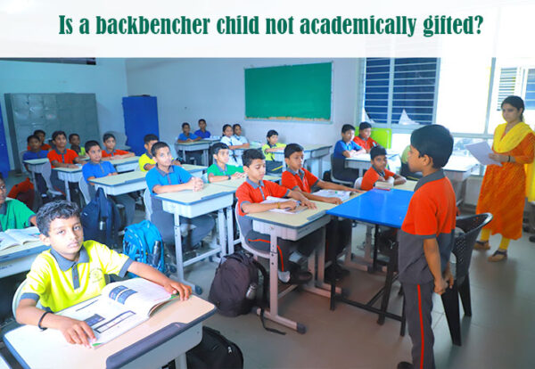 A group of backbencher children in a classroom.