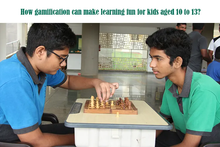 Two male students, aged 10-13, are intensely focused while playing chess on a small table, demonstrating how gamification can make learning fun and engaging.