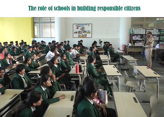 A uniformed police officer speaks to a classroom full of students in green uniforms, highlighting the role of schools in building a responsible citizen.