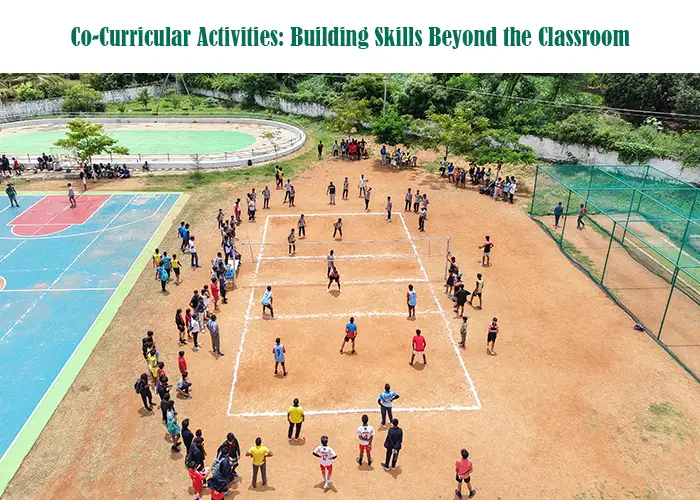 Students participating in outdoor co-curricular activities on a school ground, playing team sports while peers gather around, showcasing skill-building beyond the classroom.